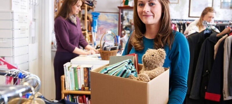 Woman donating unwanted items at Red Cross